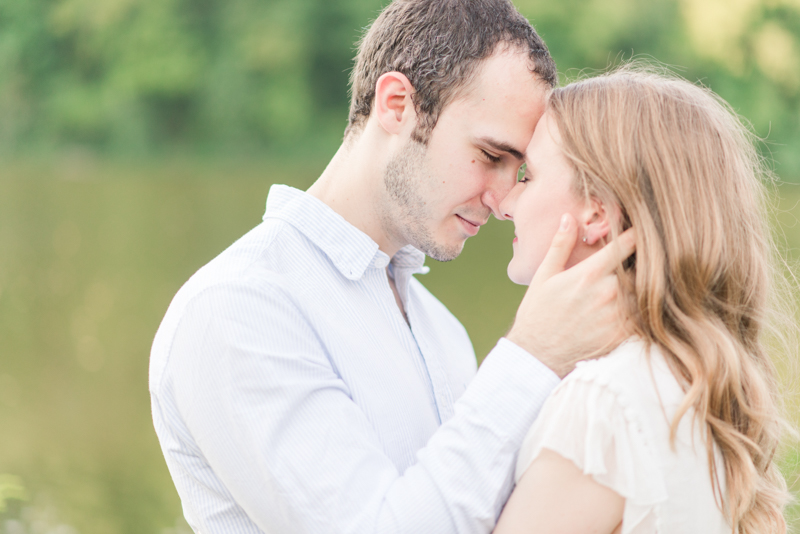 Couple at engagement session cuddling and touching foreheads