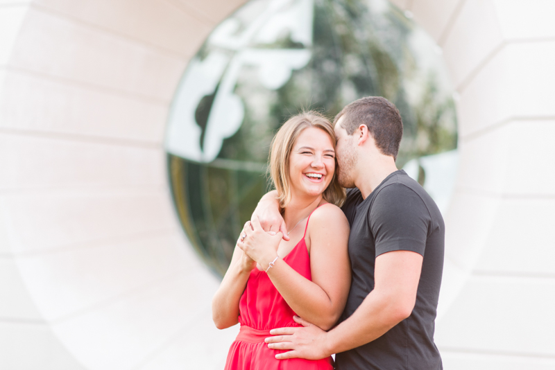 Couple during engagement session smiling and cuddling