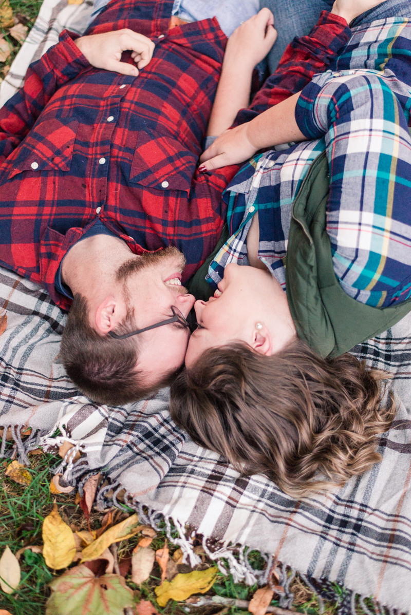 Fall engagement session laying down in Granite Hill Camping Resort