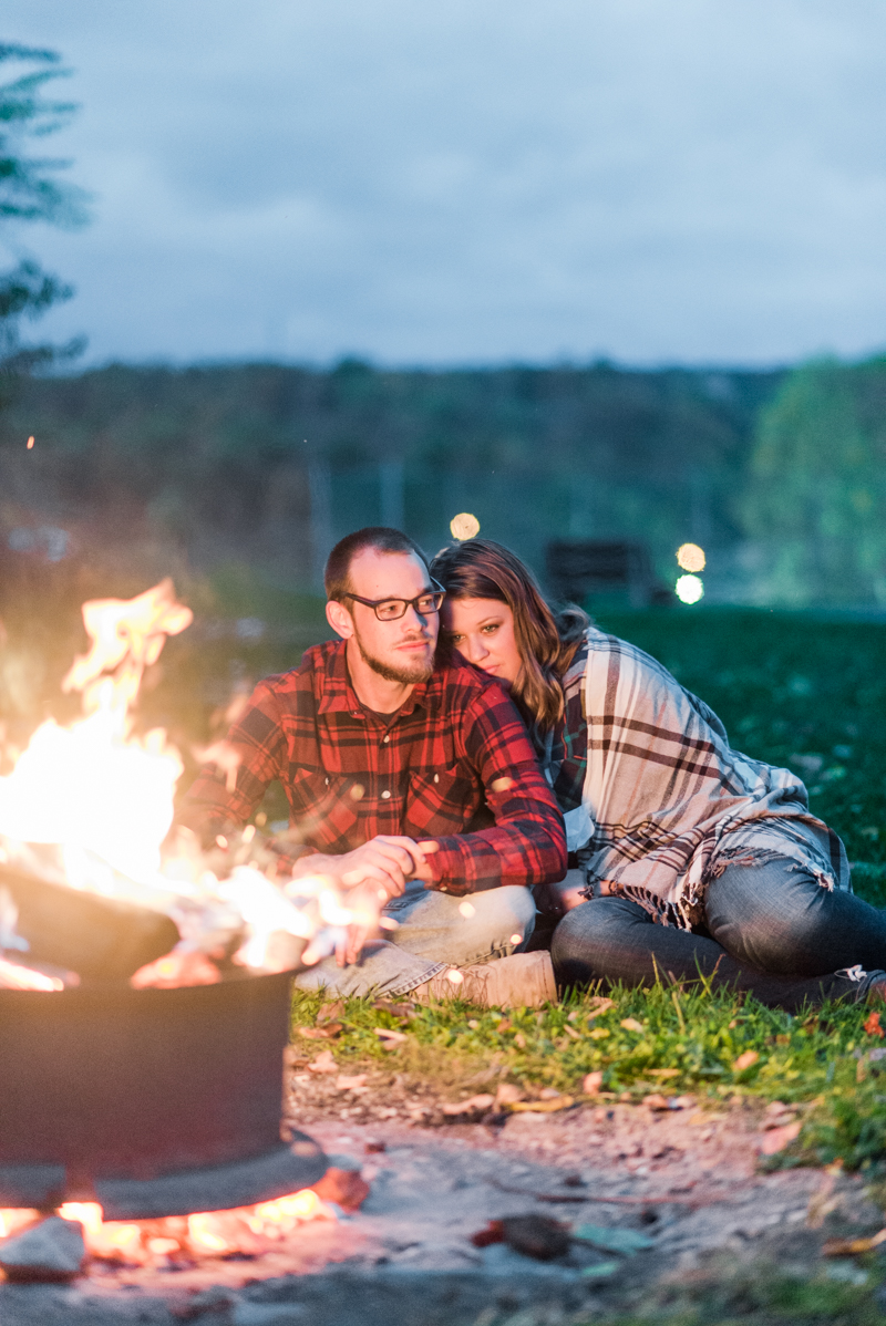 Fall engagement session by camp fire in Granite Hill Camping Resort