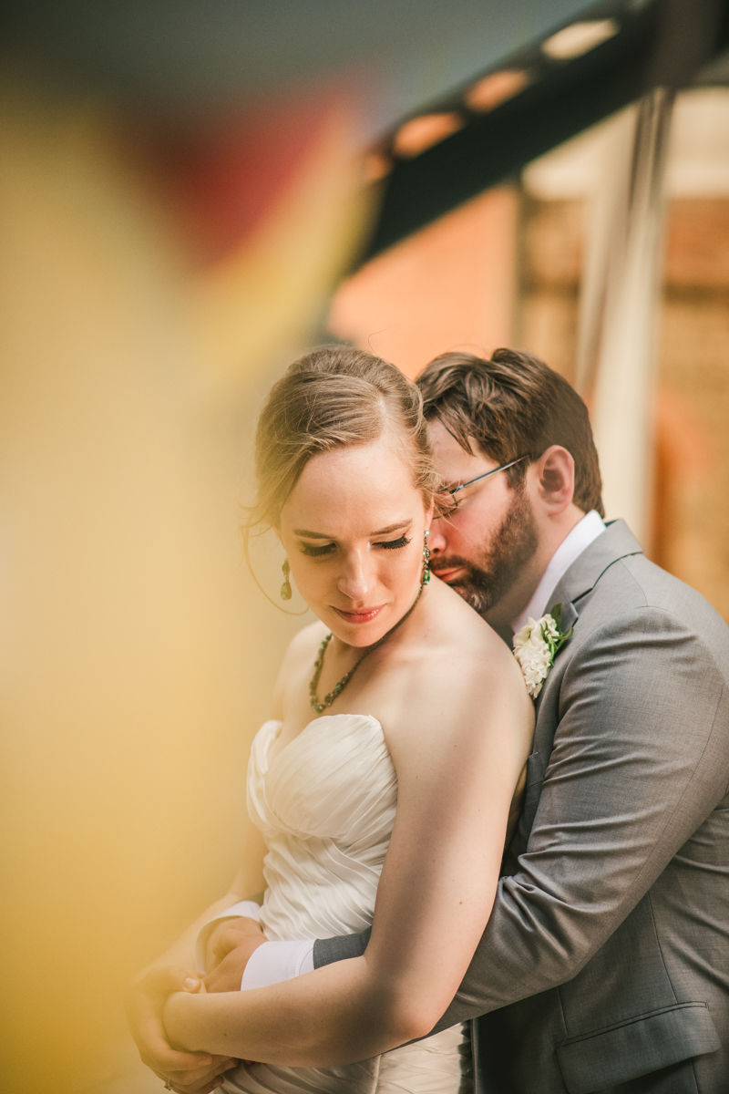 Industrial chic April wedding bride and groom portraits in Baltimore City at Clipper Mill glass sculpture by Britney Clause Photography