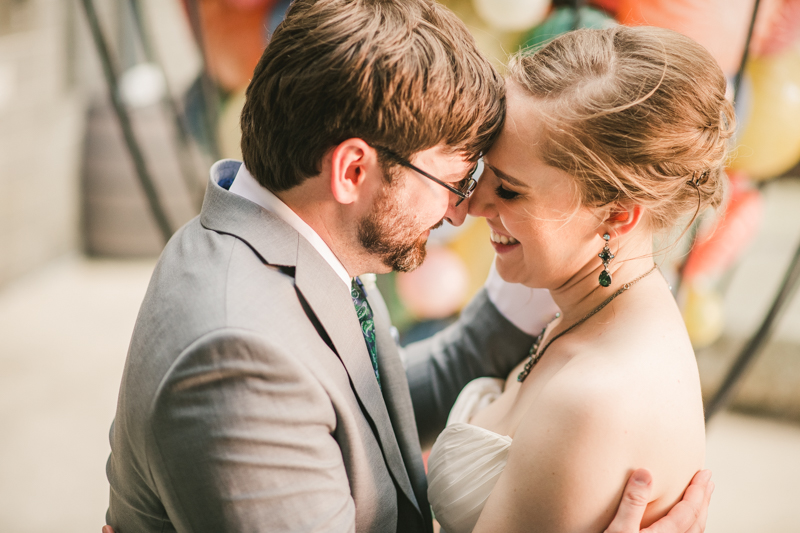 Industrial chic April wedding bride and groom portraits in Baltimore City at Clipper Mill glass sculpture by Britney Clause Photography