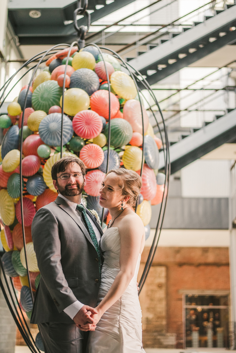 Industrial chic April wedding bride and groom portraits in Baltimore City at Clipper Mill glass sculpture by Britney Clause Photography