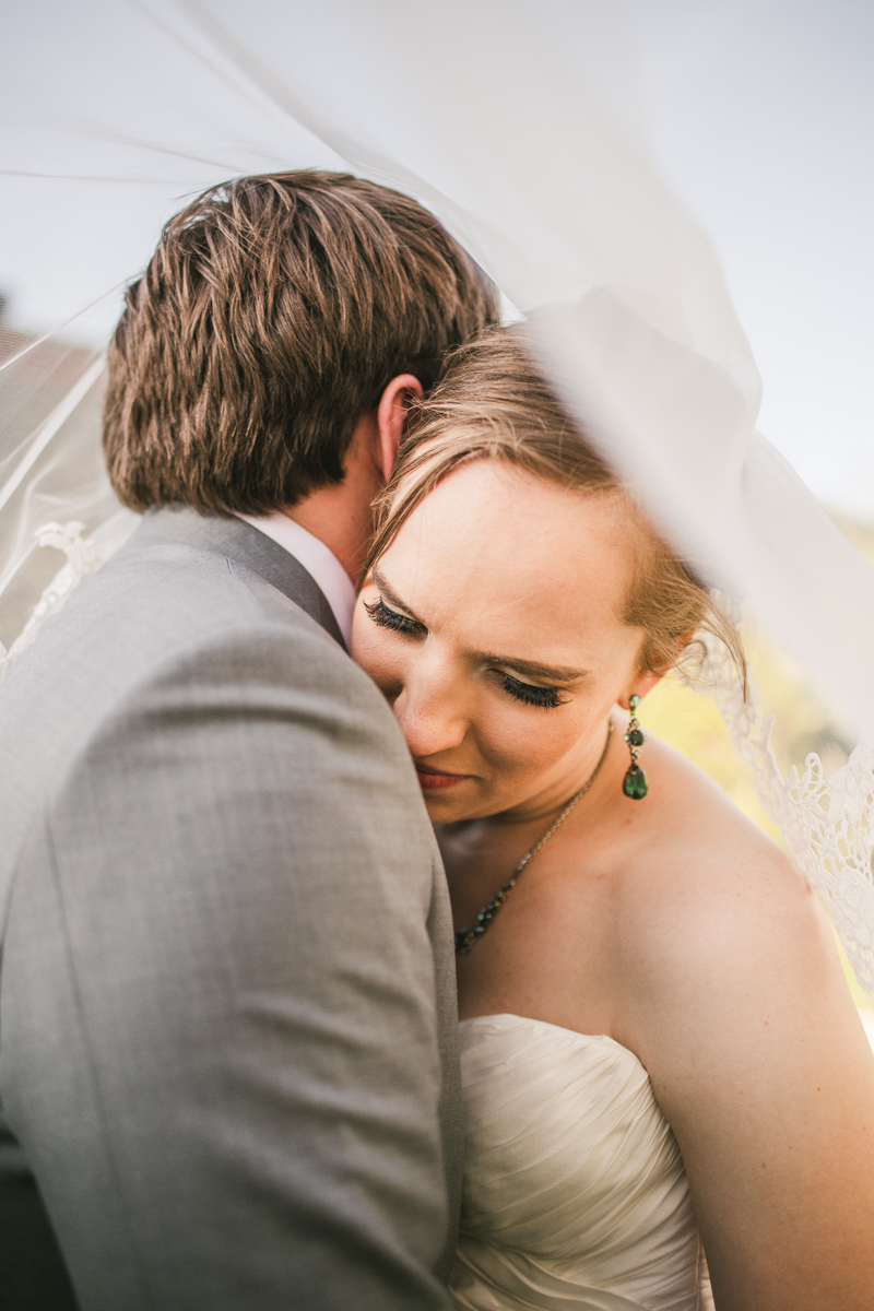 Industrial chic April wedding after party bride and groom portraits veil shot in Baltimore City at Union Mill Apartments by Britney Clause Photography