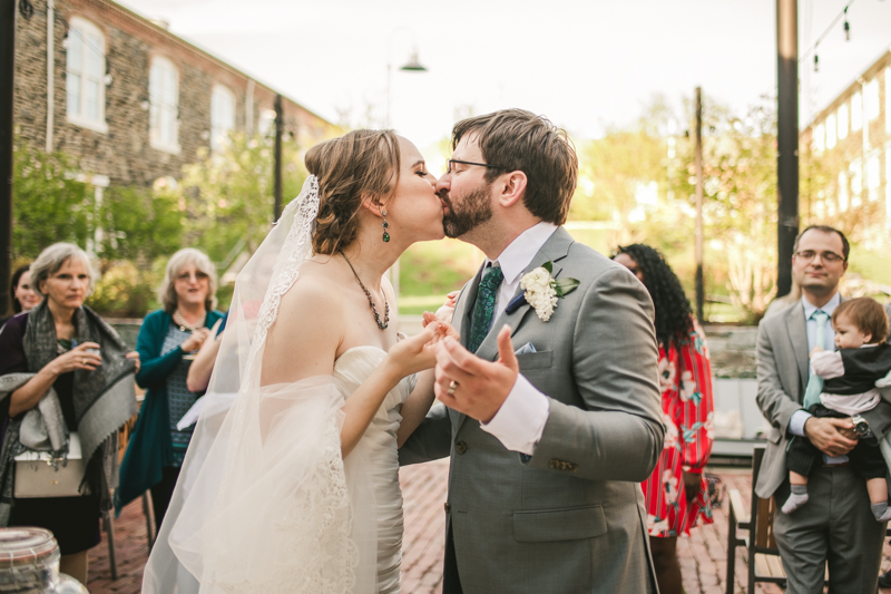 Industrial chic April wedding after party cake cutting in Baltimore City at Union Mill Apartments by Britney Clause Photography