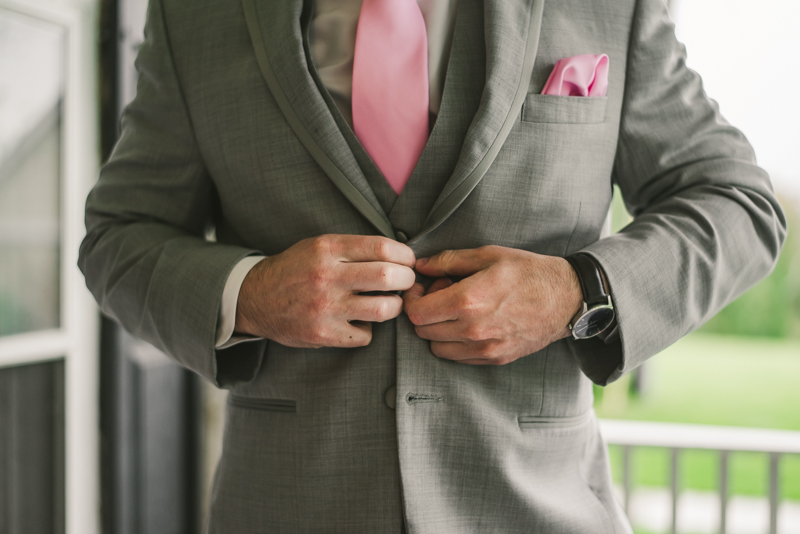 A beautiful stormy April wedding at Springfield Manor in Thurmont Maryland groom details buttoning jacket