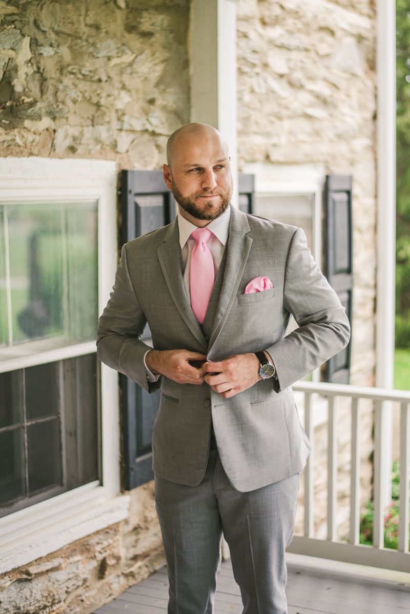 A beautiful stormy April wedding at Springfield Manor in Thurmont Maryland groom details buttoning jacket