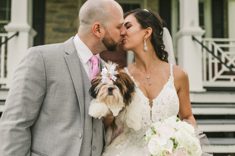 A beautiful stormy April wedding at Springfield Manor in Thurmont Maryland bride and groom portraits taken with puppy