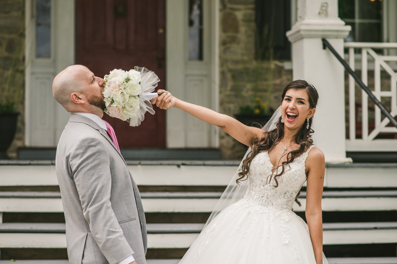 A beautiful stormy April wedding at Springfield Manor in Thurmont Maryland bride and groom portraits with bouquet in grooms face