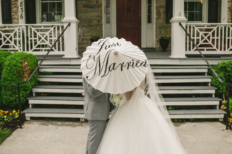 A beautiful stormy April wedding at Springfield Manor in Thurmont Maryland bride and groom portraits with just married parasol  