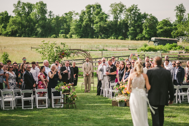 A gorgeous summer wedding ceremony at Rocklands Farm Winery in Poolesville, Maryland by Britney Clause Photography a husband and wife wedding photographer team in Maryland