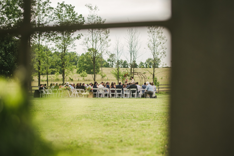 A gorgeous summer wedding ceremony at Rocklands Farm Winery in Poolesville, Maryland by Britney Clause Photography a husband and wife wedding photographer team in Maryland