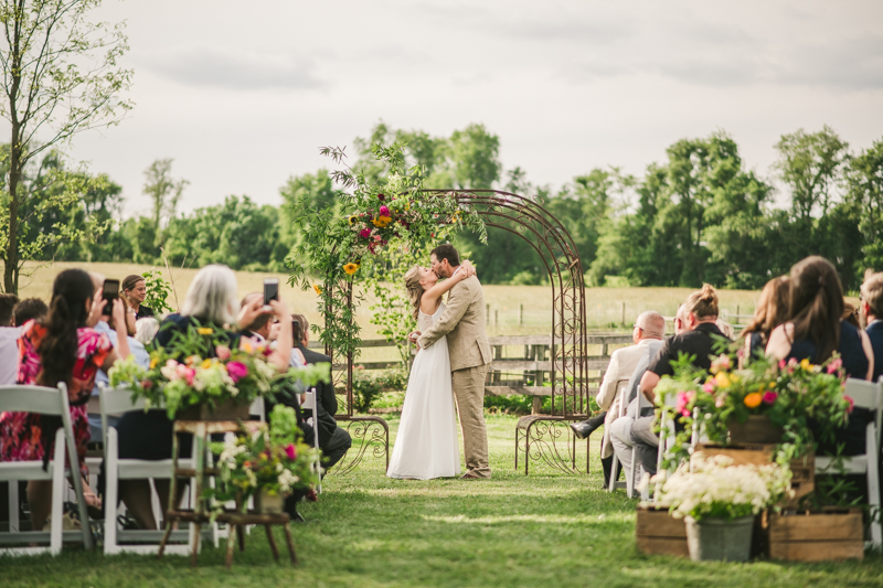 A gorgeous summer wedding ceremony at Rocklands Farm Winery in Poolesville, Maryland by Britney Clause Photography a husband and wife wedding photographer team in Maryland