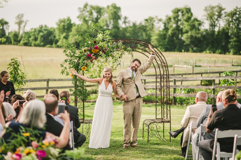 A gorgeous summer wedding ceremony at Rocklands Farm Winery in Poolesville, Maryland by Britney Clause Photography a husband and wife wedding photographer team in Maryland