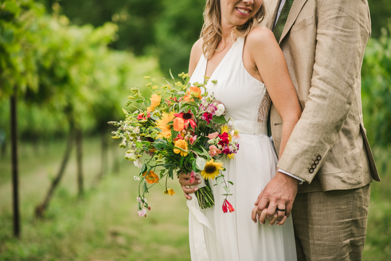 Gorgeous summer wedding florals by Sungold Flower Co at Rocklands Farm Winery in Poolesville, Maryland by Britney Clause Photography a husband and wife wedding photographer team in Maryland