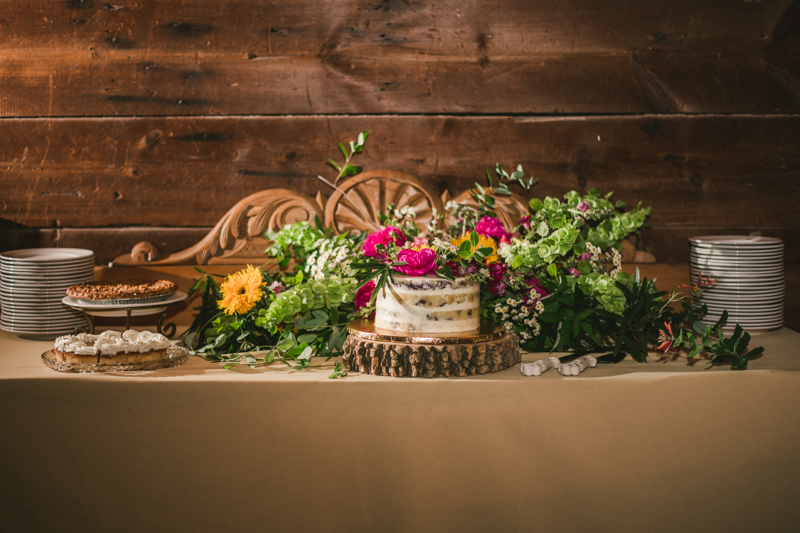 Gorgeous summer wedding reception details using farmhouse tables and Sungold Flower Co florals at Rocklands Farm Winery in Poolesville, Maryland by Britney Clause Photography a husband and wife wedding photographer team in Maryland