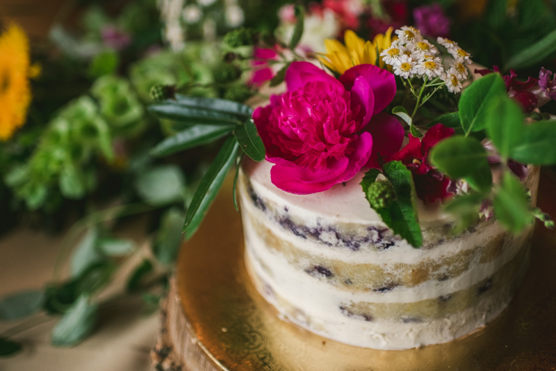 Gorgeous summer wedding reception details using farmhouse tables and Sungold Flower Co florals at Rocklands Farm Winery in Poolesville, Maryland by Britney Clause Photography a husband and wife wedding photographer team in Maryland