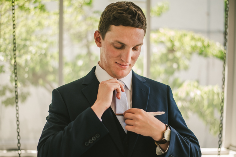 A groom getting ready for his wedding at an AirBnB in Annapolis by Britney Clause Photography, wedding photographers in Maryland