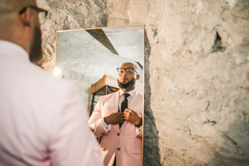 Handsome groom getting ready in Main Street Ballroom's groom suite in Ellicott City by Britney Clause Photography