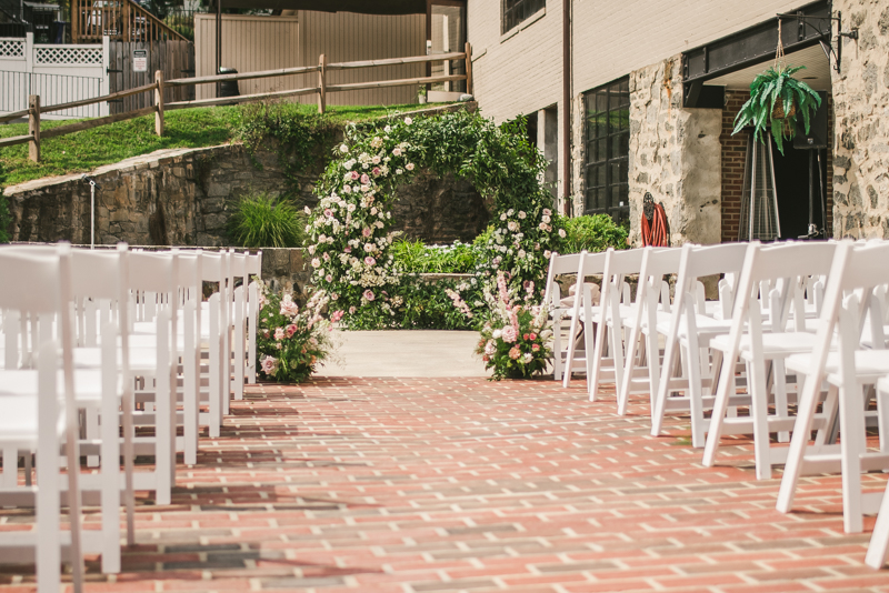 Beautiful ceremony moon arch from Flor de Casa at Main Street Ballroom in Ellicott City by Britney Clause Photography