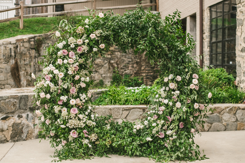 Beautiful ceremony moon arch from Flor de Casa at Main Street Ballroom in Ellicott City by Britney Clause Photography