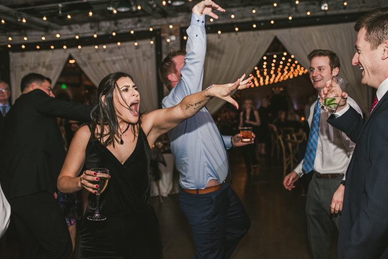 A fun and candid wedding reception at Mt Washington Mill Dye House in Baltimore, Maryland. Captured by Britney Clause Photography