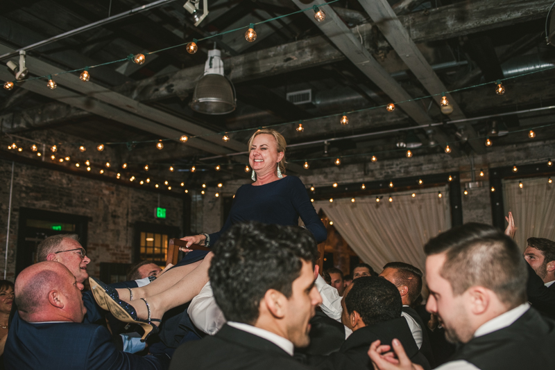 A fun and candid wedding reception at Mt Washington Mill Dye House in Baltimore, Maryland. Captured by Britney Clause Photography