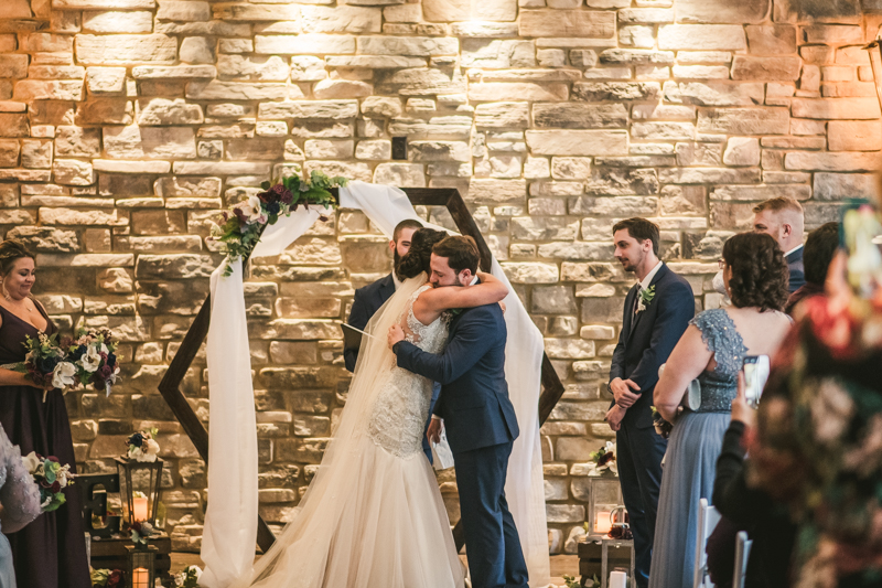 An emotional groom waiting for his bride at the end of the aisle at Kurtz's Beach in Pasadena, Maryland. Photo by Britney Clause Photography