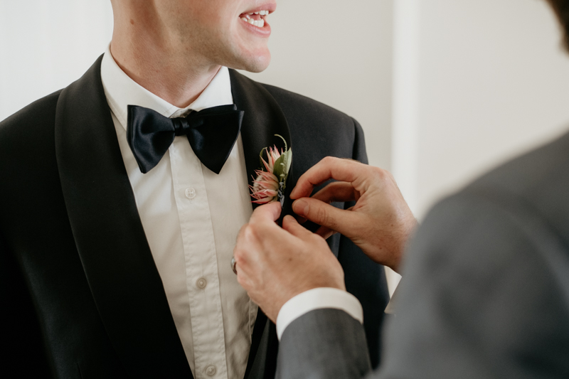 A groom getting ready for his wedding in Folly Beach, South Carolina by Britney Clause Photography