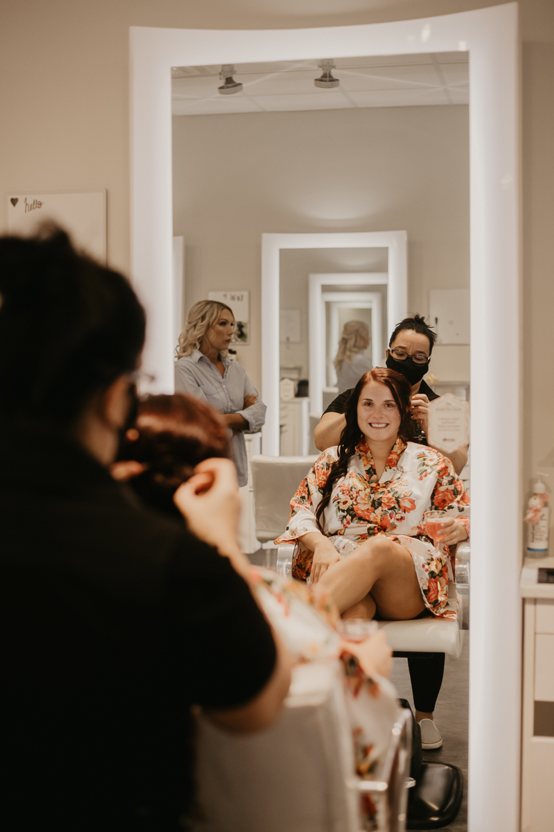 A bride getting ready at Tough Love Salon for her Anchor Inn wedding at in Pasadena, Maryland by Britney Clause Photography