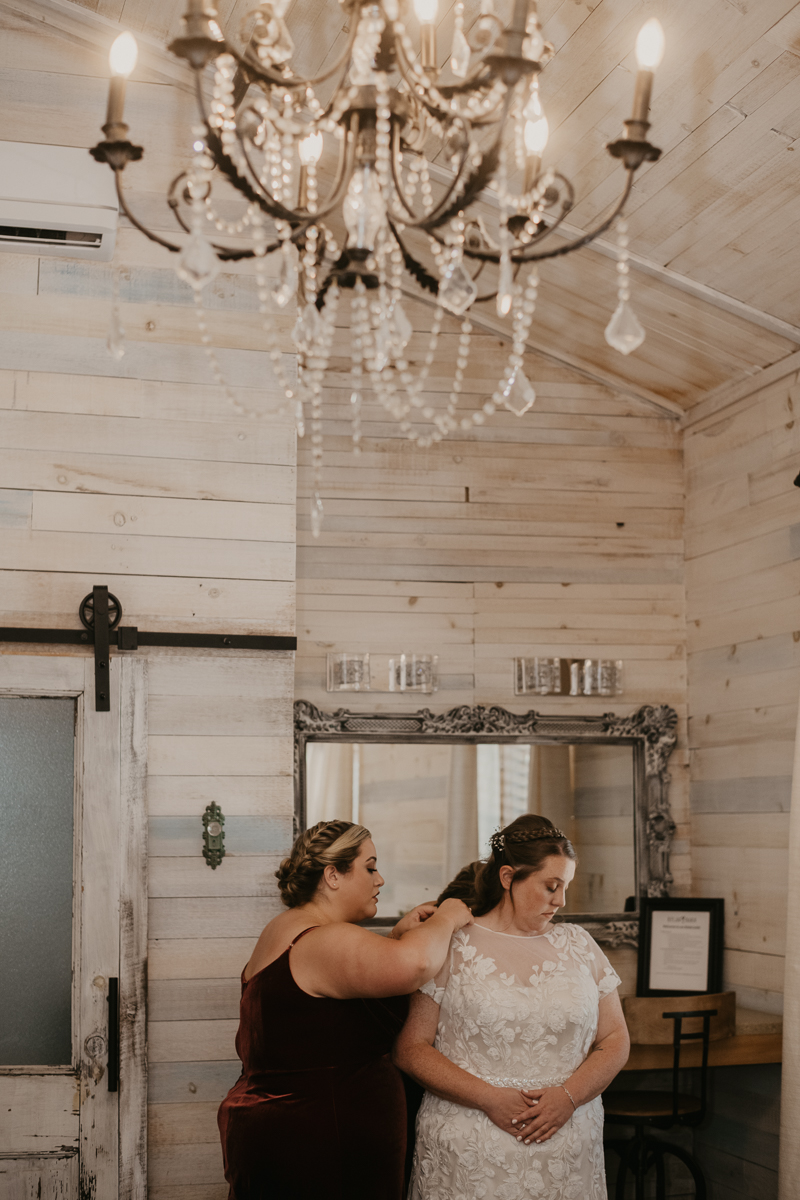 A bride getting ready for her wedding at Kylan Barn in Delmar, Maryland by Britney Clause Photography