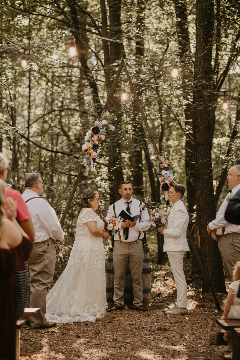 Amazing same sex wedding ceremony in the woods at Kylan Barn in Delmar, Maryland by Britney Clause Photography