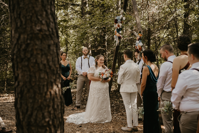 Amazing same sex wedding ceremony in the woods at Kylan Barn in Delmar, Maryland by Britney Clause Photography