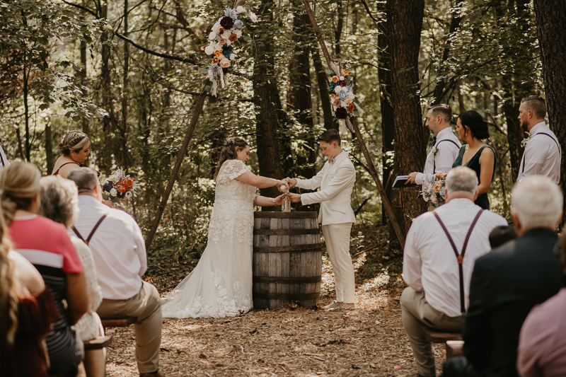 Amazing same sex wedding ceremony in the woods at Kylan Barn in Delmar, Maryland by Britney Clause Photography