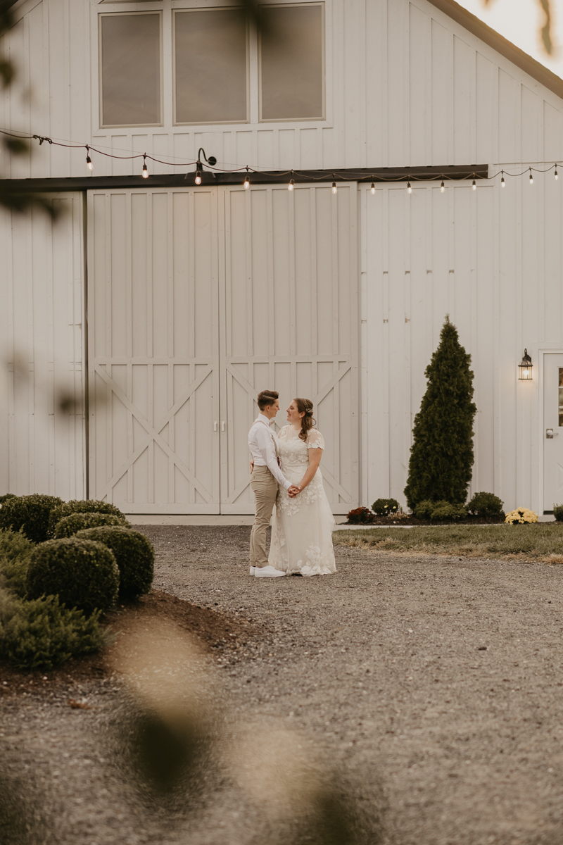 Stunning bride and bride sunset wedding portraits at Kylan Barn in Delmar, Maryland by Britney Clause Photography