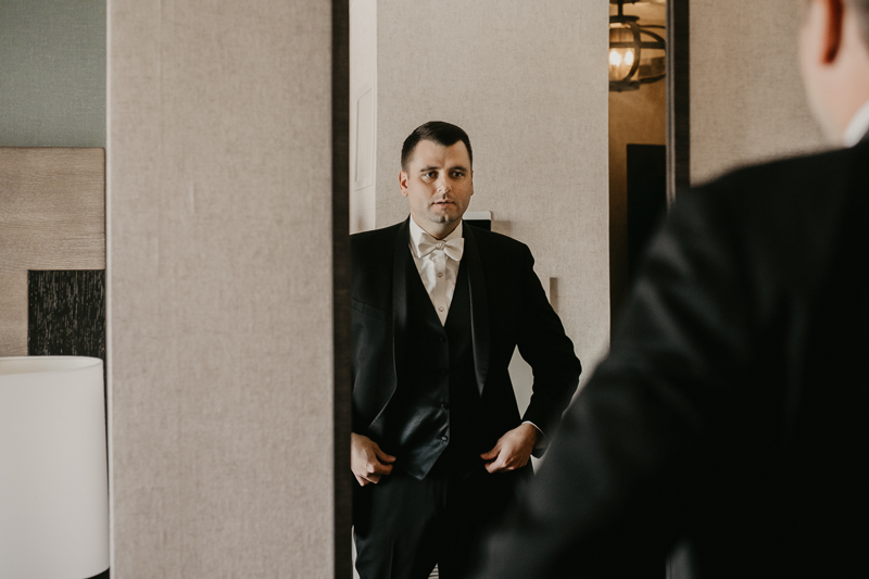 A groom getting ready for his wedding at The Hyatt Regency Chesapeake Bay, Maryland by Britney Clause Photography