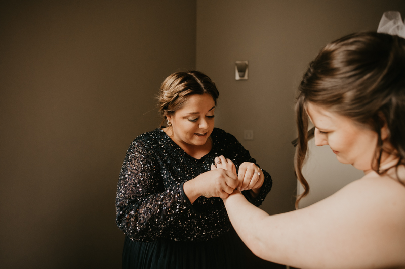 A bride getting ready at the Hotel Indigo for her Heron Room wedding in Baltimore, Maryland by Britney Clause Photography