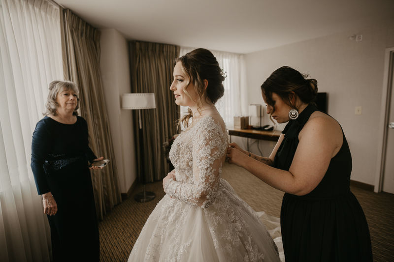 A bride getting ready at the Homewood Suites Hilton Hotel for a Mt. Washington Mill Dye House in Baltimore, Maryland by Britney Clause Photography