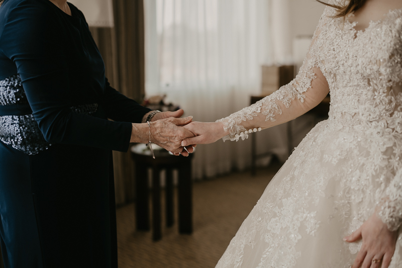 A bride getting ready at the Homewood Suites Hilton Hotel for a Mt. Washington Mill Dye House in Baltimore, Maryland by Britney Clause Photography