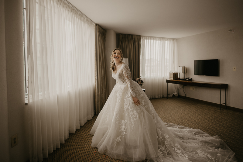 A bride getting ready at the Homewood Suites Hilton Hotel for a Mt. Washington Mill Dye House in Baltimore, Maryland by Britney Clause Photography