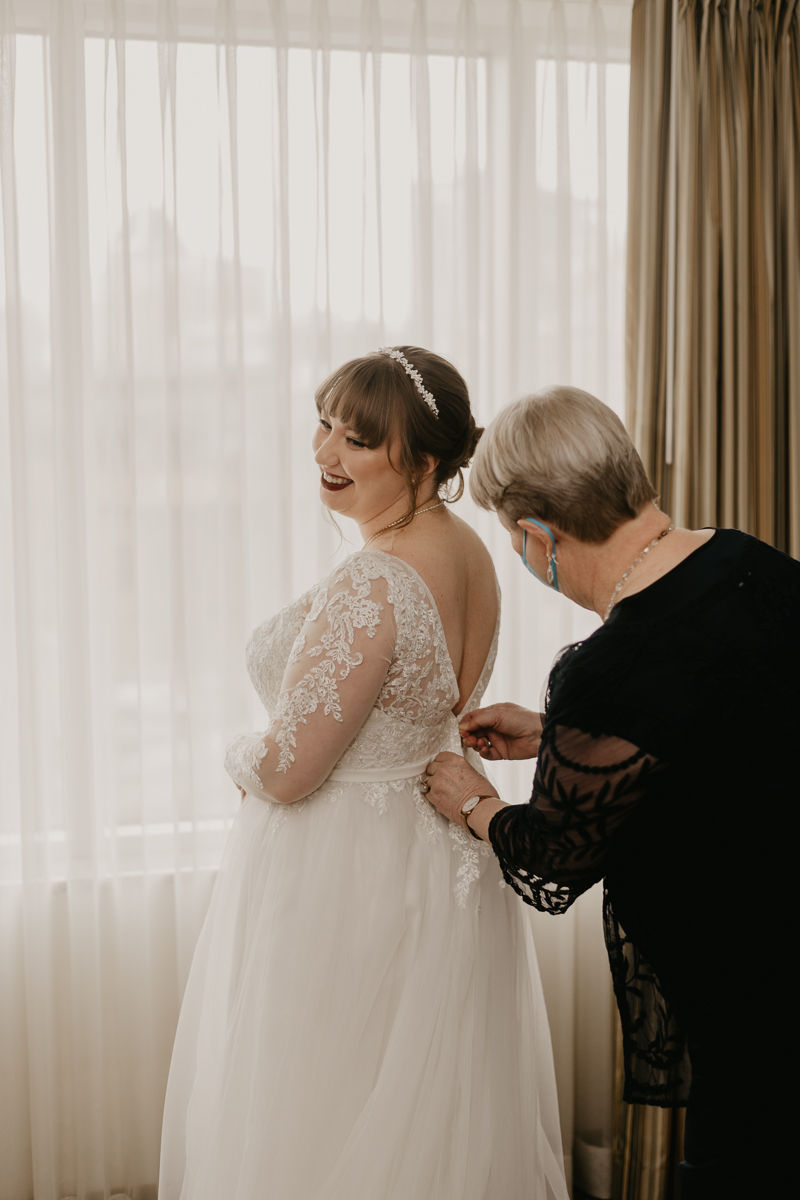 A bride getting ready at the Homewood Suites Hilton Hotel for a Mt. Washington Mill Dye House in Baltimore, Maryland by Britney Clause Photography