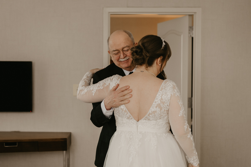 A bride getting ready at the Homewood Suites Hilton Hotel for a Mt. Washington Mill Dye House in Baltimore, Maryland by Britney Clause Photography