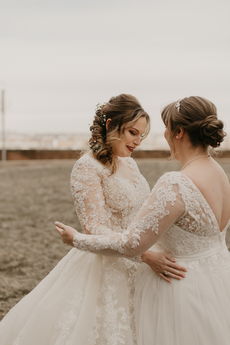 Stunning bride and bride wedding portraits at the Homewood Suites Hilton Hotel for a Mt. Washington Mill Dye House in Baltimore, Maryland by Britney Clause Photography