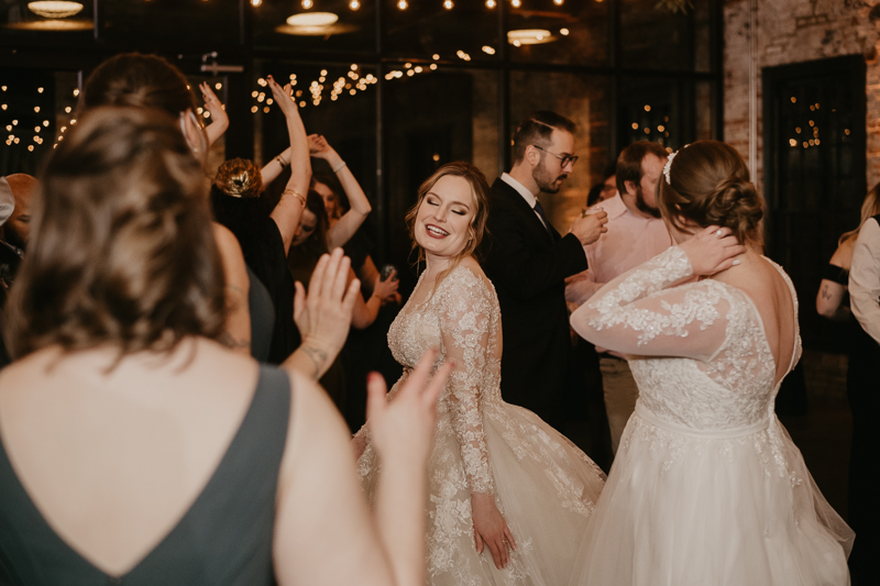 A bright and light filled evening wedding reception by District Remix DJs at the Mt. Washington Mill Dye House in Baltimore, Maryland by Britney Clause Photography