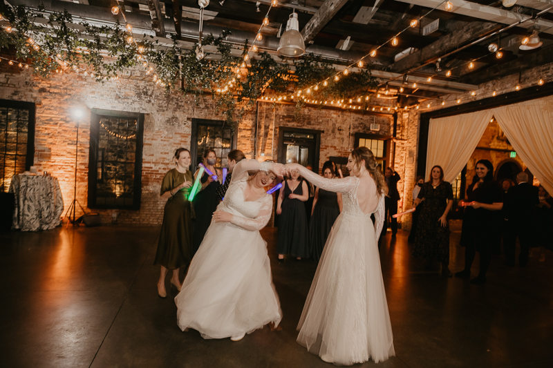 A bright and light filled evening wedding reception by District Remix DJs at the Mt. Washington Mill Dye House in Baltimore, Maryland by Britney Clause Photography