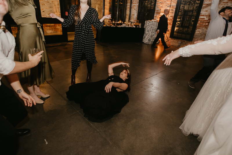 A bright and light filled evening wedding reception by District Remix DJs at the Mt. Washington Mill Dye House in Baltimore, Maryland by Britney Clause Photography