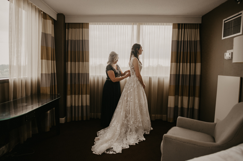 A bride getting ready at the Sheraton Baltimore North Hotel for a Mt. Washington Mill Dye House in Baltimore, Maryland by Britney Clause Photography