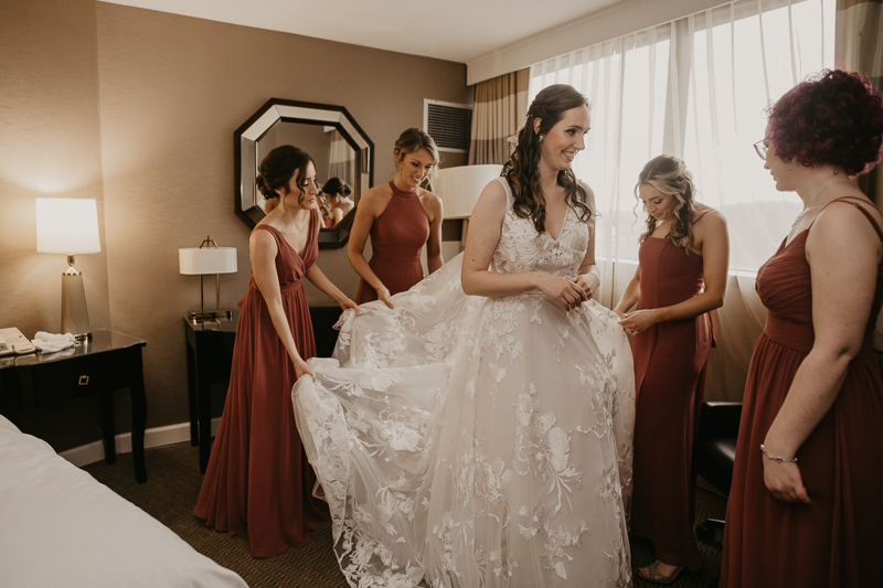 A bride getting ready at the Sheraton Baltimore North Hotel for a Mt. Washington Mill Dye House in Baltimore, Maryland by Britney Clause Photography