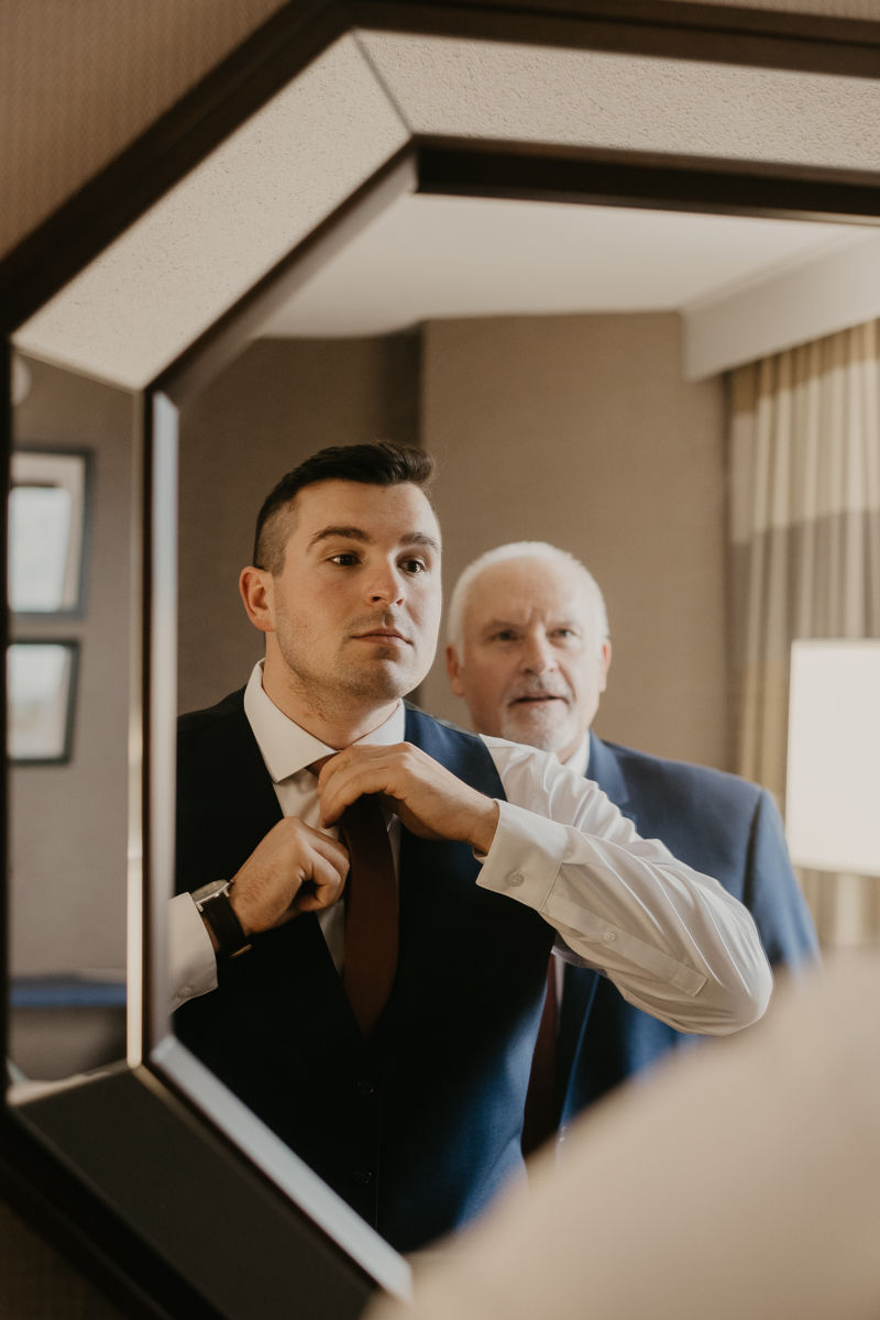 A groom getting ready at the Sheraton Baltimore North Hotel for a Mt. Washington Mill Dye House in Baltimore, Maryland by Britney Clause Photography