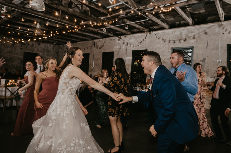 A bright and light filled evening wedding reception by District Remix DJs at the Mt. Washington Mill Dye House in Baltimore, Maryland by Britney Clause Photography